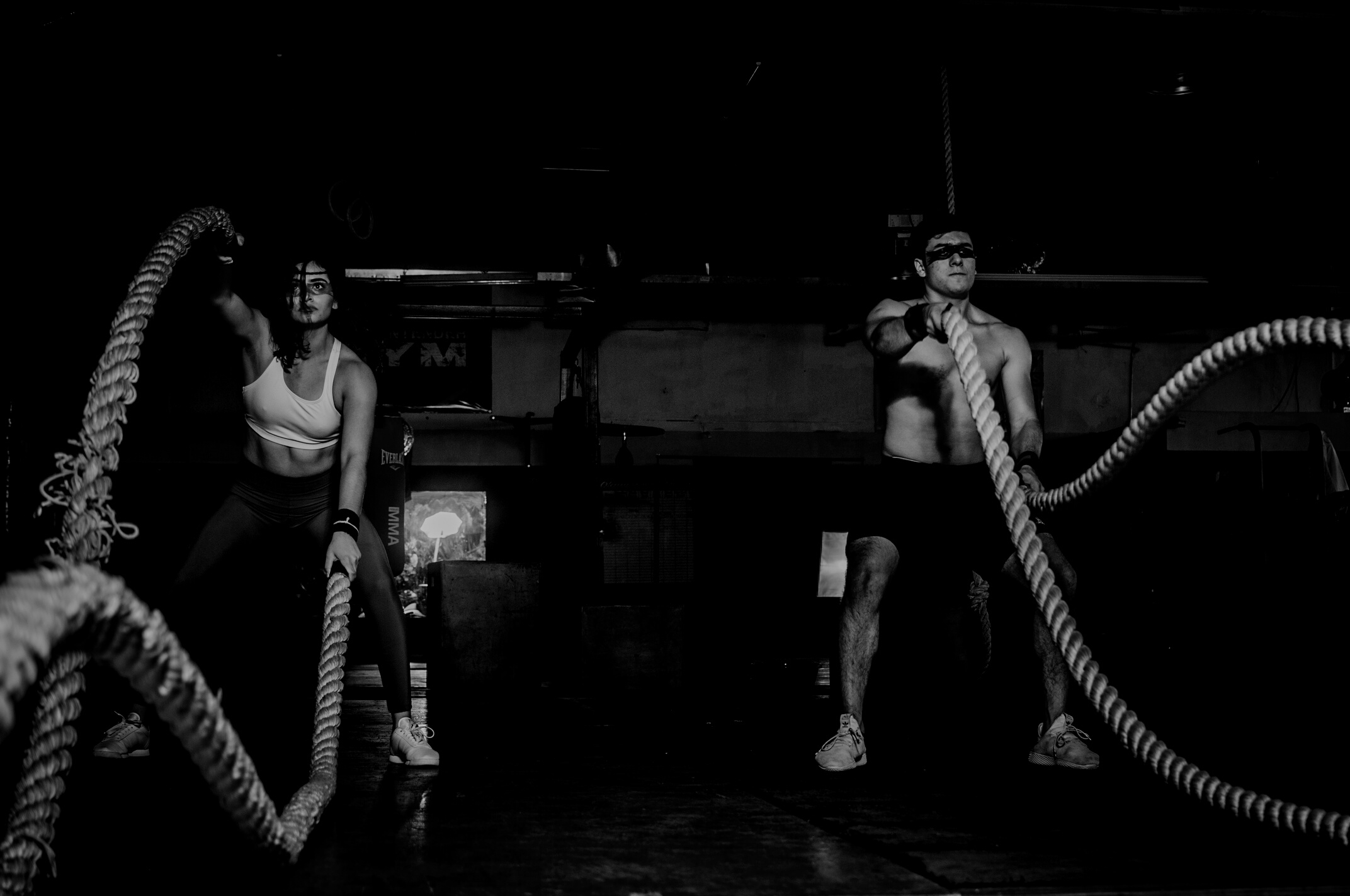 Man And Woman Holding Battle Ropes